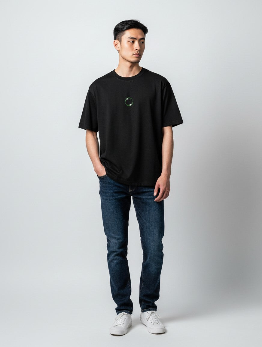 Born West black oversized terry-knit tee with a small, glowing neon green crystal graphic on the chest.