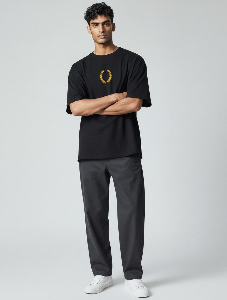 Born West black oversized terry tee with gold laurel wreath graphic on chest. Heavyweight cotton blend.