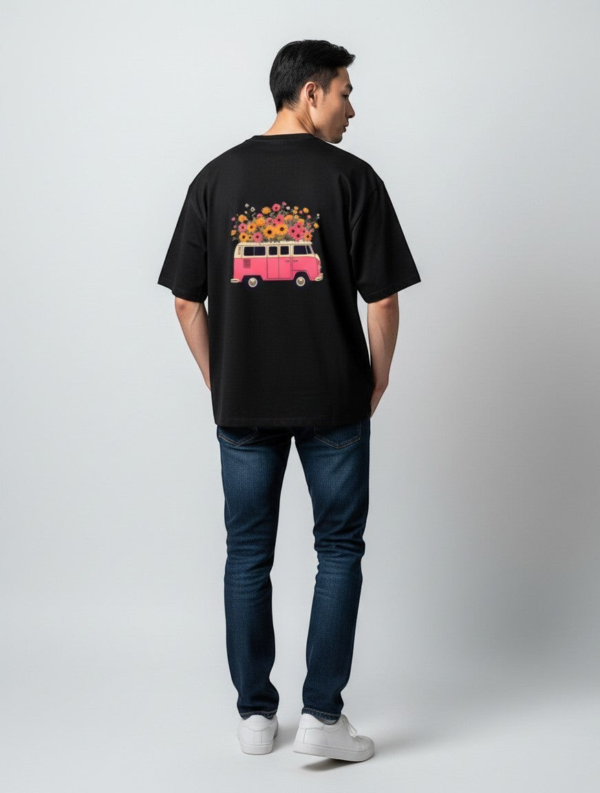 Born West black oversized terry tee with a pink retro camper van graphic overflowing with colorful wildflowers.