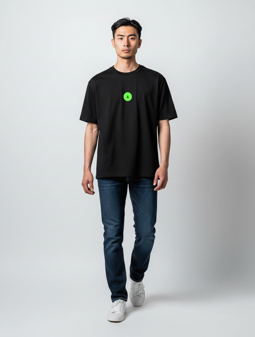 Born West black oversized terry tee with a small neon green circular graphic on the chest.
