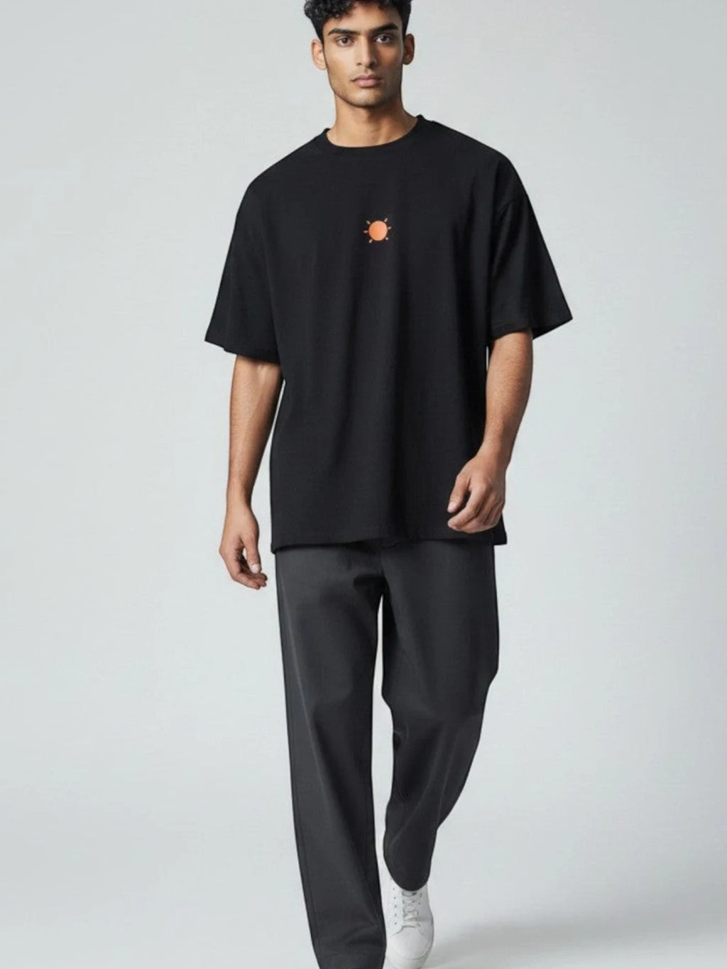 Born West black oversized terry tee with orange sun graphic on chest. 90/10 cotton-poly blend.