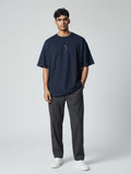 Born West oversized navy blue cotton blend tee with a small gold celestial graphic on the chest.