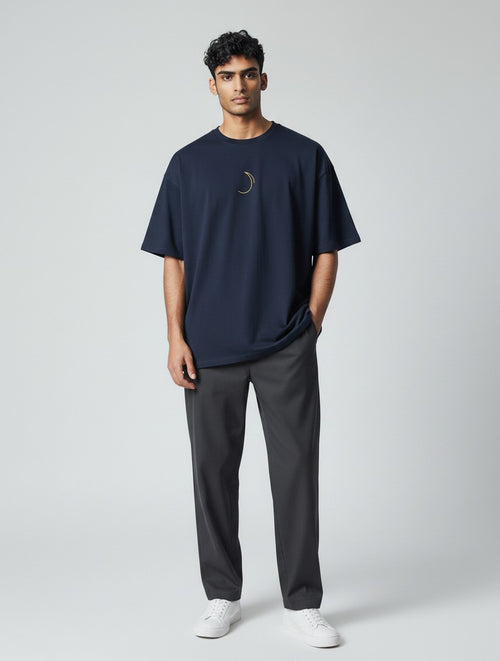 Born West oversized navy blue cotton blend tee with a small gold celestial graphic on the chest.