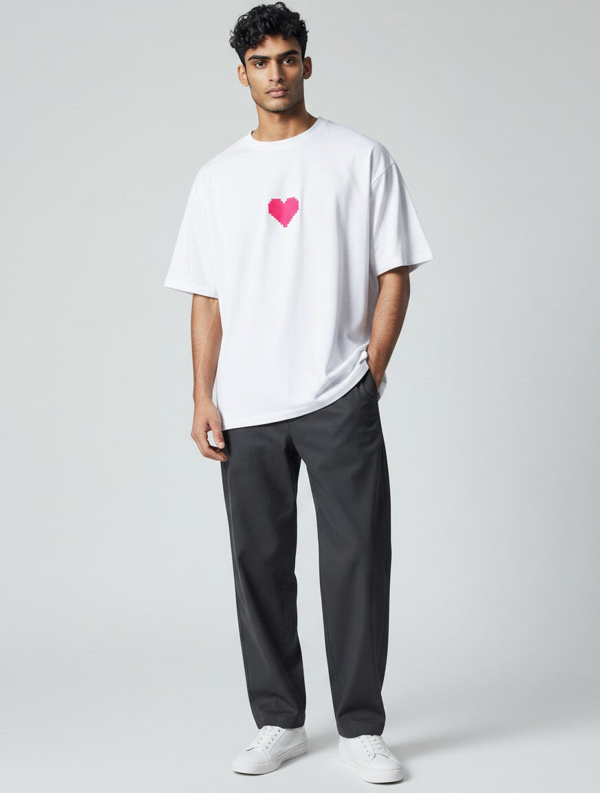Born West white oversized terry tee with a small pixelated pink heart graphic on the chest.