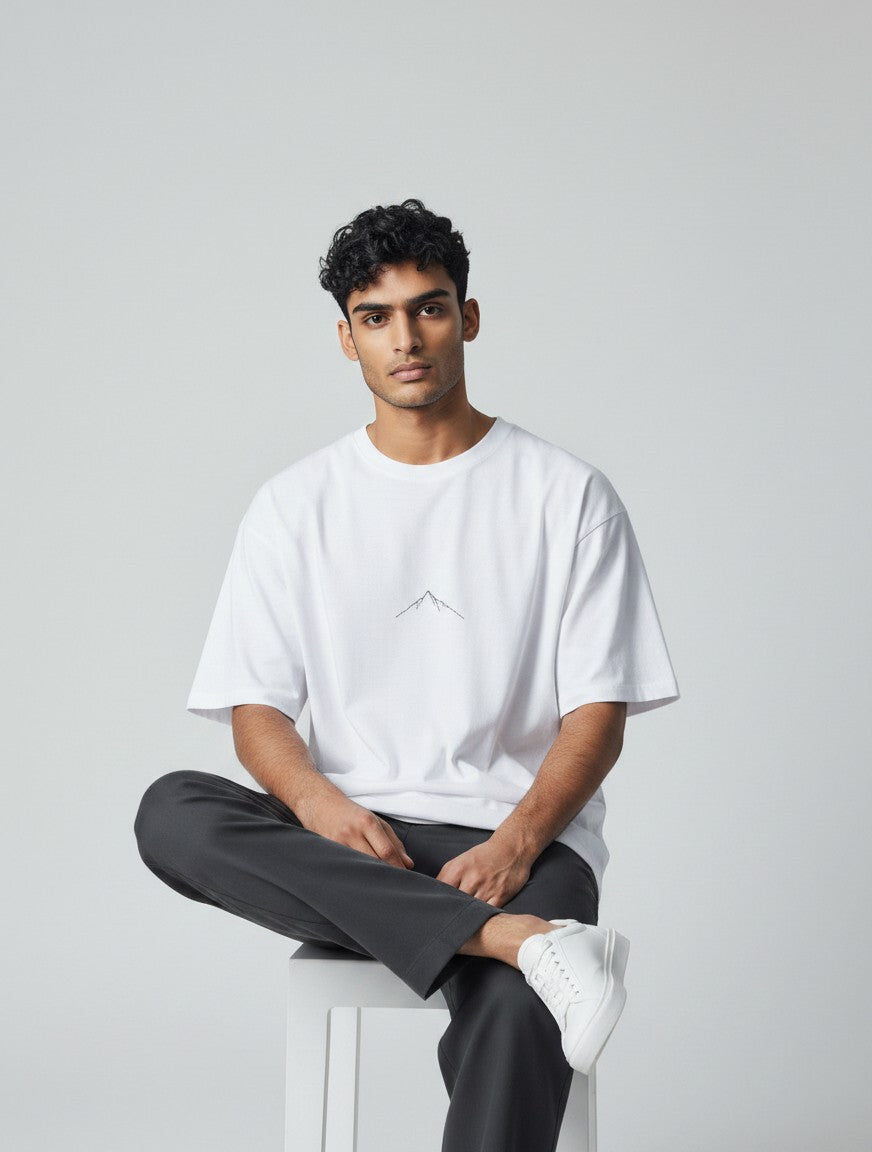 Born West white oversized terry knit t-shirt with minimalist mountain graphic on chest. 90/10 cotton-poly blend.