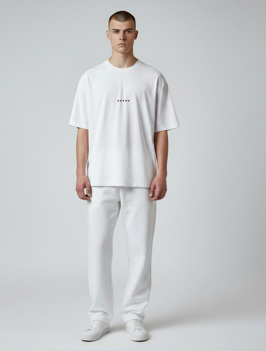 Born West white terry-knit oversized t-shirt with a small maroon dot graphic on the chest.