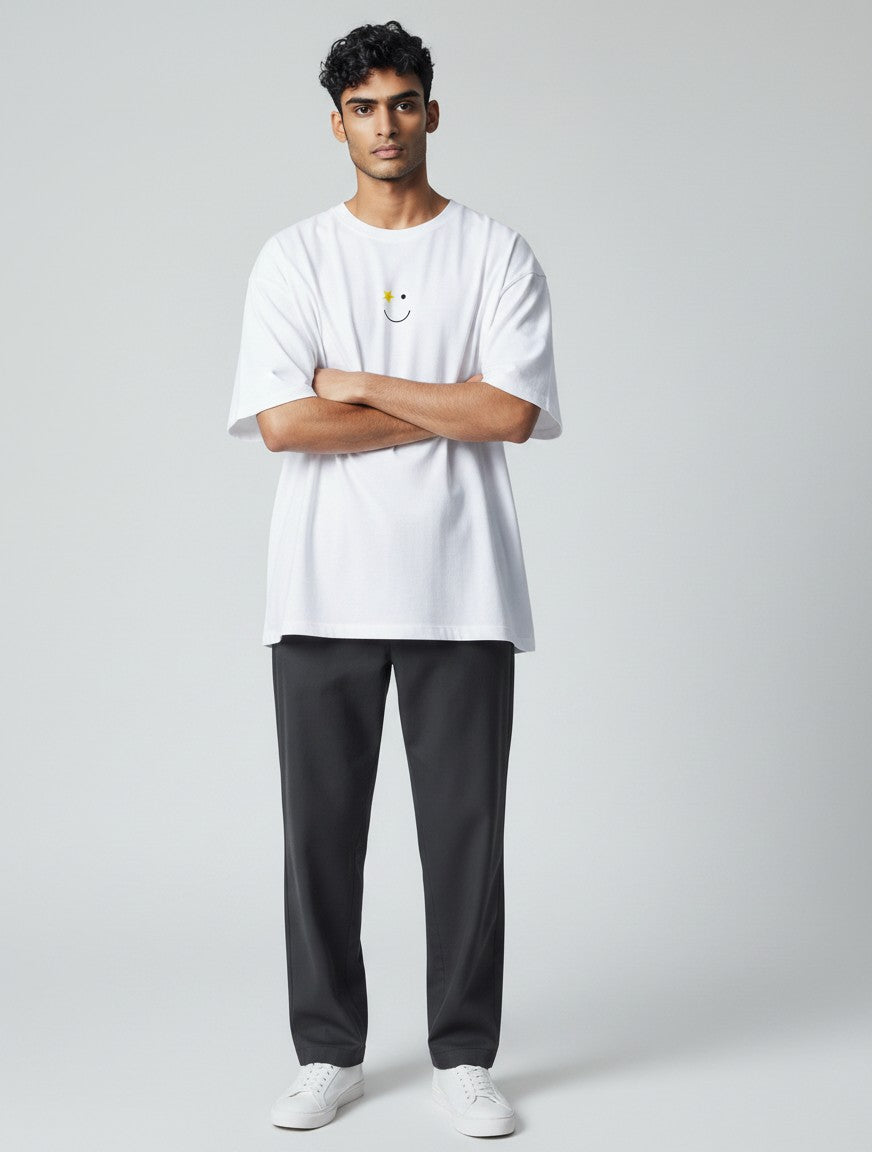 Born West white oversized terry tee with a small yellow star and smiley face graphic on the chest.