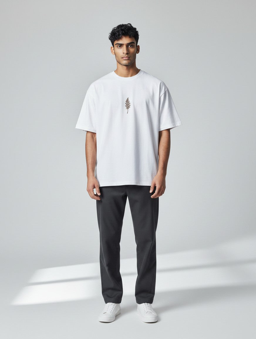 Born West white terry knit t-shirt with a small dark brown botanical vine graphic on the chest. Oversized fit.